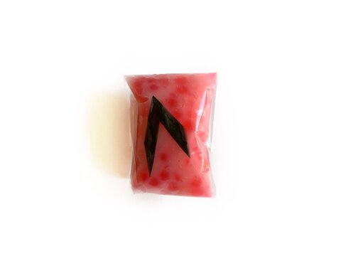Jenang Mutiara, Indonesian traditional sweet porridge made of tapioca pearls with coconut milk, isolated on white background. Popular pink sago dessert for Ramadan iftar and cultural snacks.