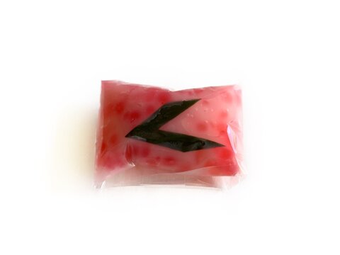 Jenang Mutiara, Indonesian traditional sweet porridge made of tapioca pearls with coconut milk, isolated on white background. Popular pink sago dessert for Ramadan iftar and cultural snacks.