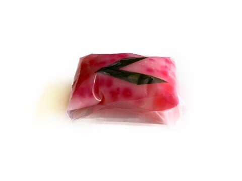 Jenang Mutiara, Indonesian traditional sweet porridge made of tapioca pearls with coconut milk, isolated on white background. Popular pink sago dessert for Ramadan iftar and cultural snacks.