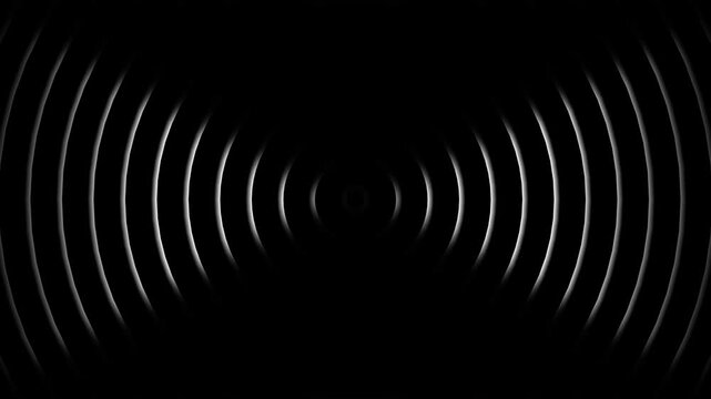 Concentric circles radiate from a central point in a dark abstract design