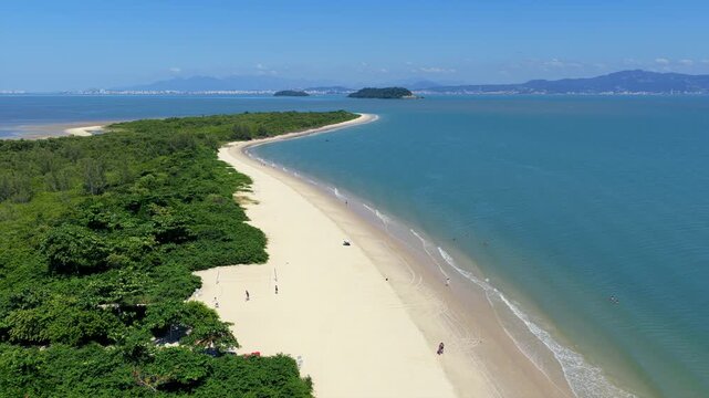 Aerial drone shot flying over Daniela Beach coastline in Florianopolis, perfect for travel and tropical vacation concepts.
