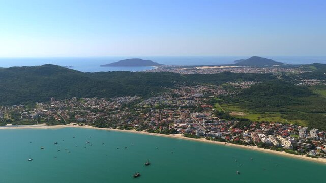 Aerial view of coastal city and Cachoeira do Bom Jesus beach in Florianopolis, ideal for travel and urban lifestyle concepts.