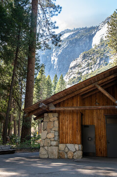 Yosemite Falls building with trees mountains in the background