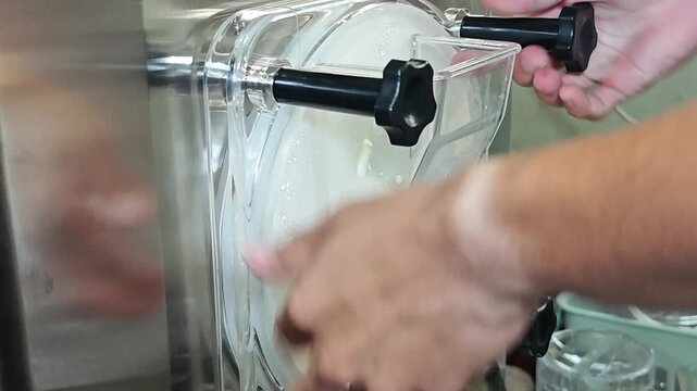 Ice cream maker machine. Ice cream falls into container.