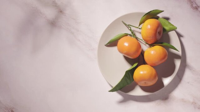 resh citrus fruit with mandarins and oranges on plate, minimal composition with copy space and sunlight shadows, organic healthy food background, modern lifestyle concept, natural vitamin C source