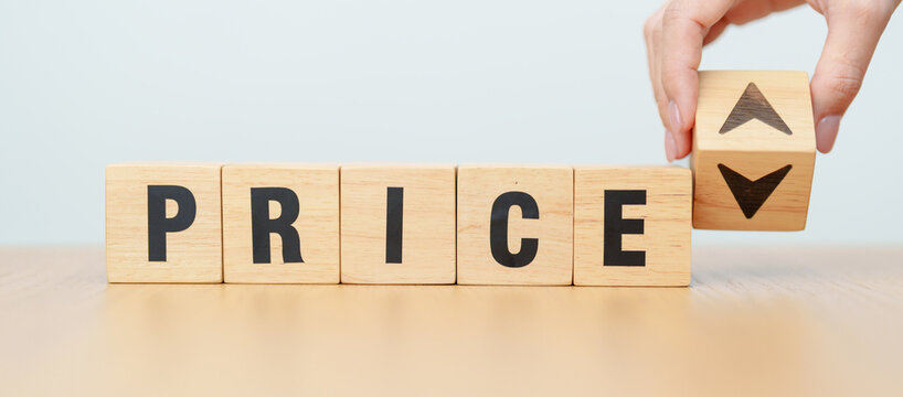 hand change wooden block with PRICE text to UP and Down arrow icon. Sale marketing, Price decrease and Increase Financial, money Value, discount, consumption, investment and purchases concept