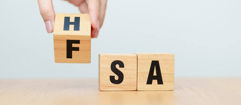 hand change wooden block from FSA to HSA. Flexible Spending Account and Health Savings Account, Medical Expenses, Tax Benefits and healthcare concepts