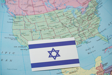 Naklejka premium Close up of Israel flag on United States map.