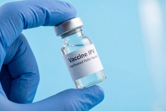 Gloved hand holding vaccine IPV vial for polio immunization