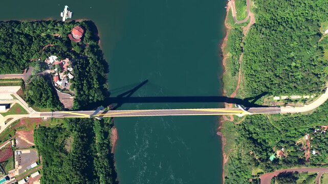 Top-down aerial drone view of the Puente de la Integracion over the Parana River on the Brazil and Paraguay border.