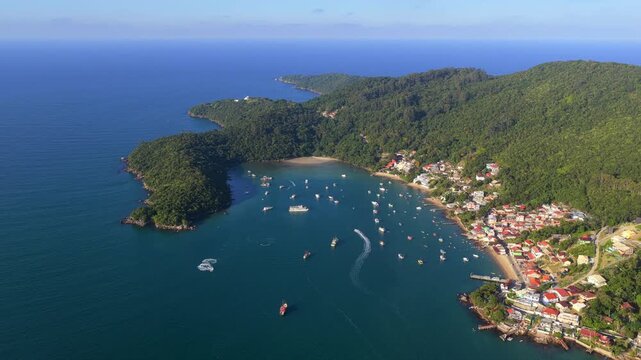 Aerial view of Caixa Daco bay in Porto Belo, Brazil, boats anchored in turquoise water surrounded by lush coastline.
