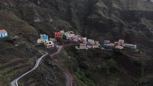 Panoramic drone view of Fontainhas village, uniquely perched on a mountain ridge in Santo Antao, Cabo Verde. Colorful houses and terraced agriculture in a deep volcanic valley landscape