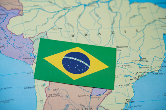 Close up of Brazil flag on map of Brazil.