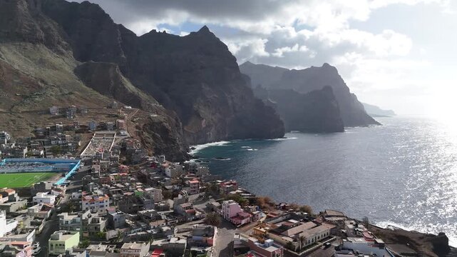 drone sunset view of Ponta do Sol nestled under towering volcanic peaks in Santo Antao. Drone view of the urban settlement and spectacular coastal scenery in Cape Verde