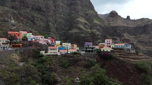drone view of Iconic colorful houses in a deep volcanic valley Fontainhas village perched on cliffs in Santo Antao, Cape Verde aerial footage