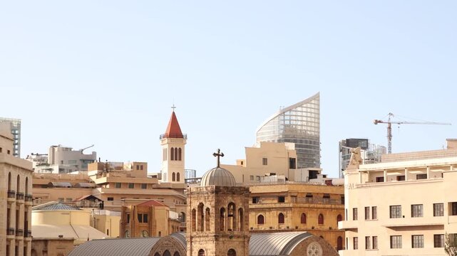 Scenic view of Saint George Maronite Cathedral and historic churches in Beirut downtown. A mix of ancient religious heritage and modern skyscrapers in the capital of Lebanon