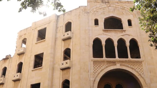Tilt up shot of a historic Ottoman-style building in downtown Beirut. Traditional stone arches and intricate windows showcasing Lebanon's rich architectural heritage and colonial history
