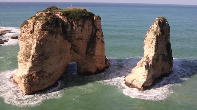 Aerial view of the Raouche Rocks, also known as Pigeons Rock, in Beirut. Iconic limestone formations standing in the Mediterranean Sea along the Corniche of Lebanon's capital city