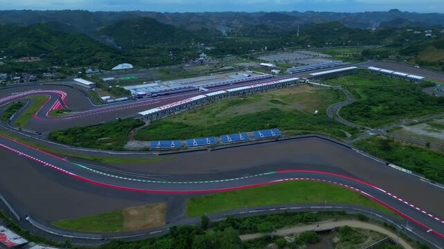 modern motorsports race track with its grandstands and paddock buildings, ready for high speed competition. Perfect aerial view drone shot panorama from above