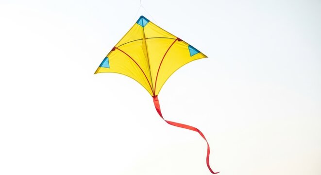 Vibrant yellow kite with blue accents flying in the sky outdoors