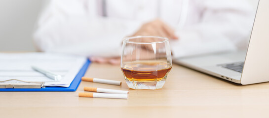 doctor hand making stop sign to refuse whiskey and breaking cigarette, quit smoking and drinking for healthy liver and lung, World No Tobacco and  No Alcohol Day and stop alcohol addiction concept © Jo Panuwat D