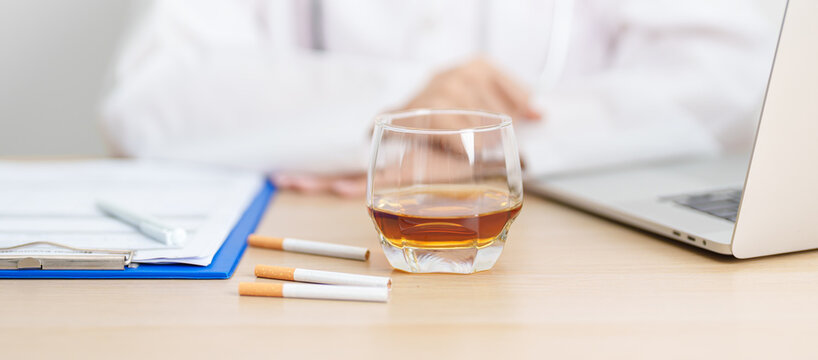 doctor hand making stop sign to refuse whiskey and breaking cigarette, quit smoking and drinking for healthy liver and lung, World No Tobacco and  No Alcohol Day and stop alcohol addiction concept