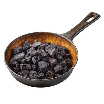 Charcoal chunks in cast iron skillet, rustic cooking fuel, barbecue material, outdoor grilling isolated on Transparent Background
