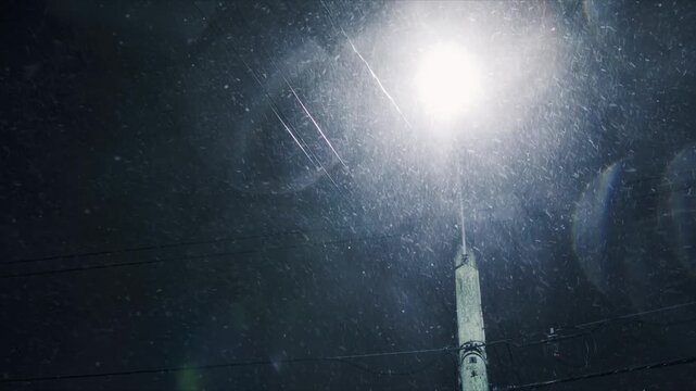 street-level night view severe snowstorm in Beechville, Nova Scotia, Canada. Strong winds pile up snowdrifts, completely blocking roads and sidewalks, streetlights struggling to shine through blizzard