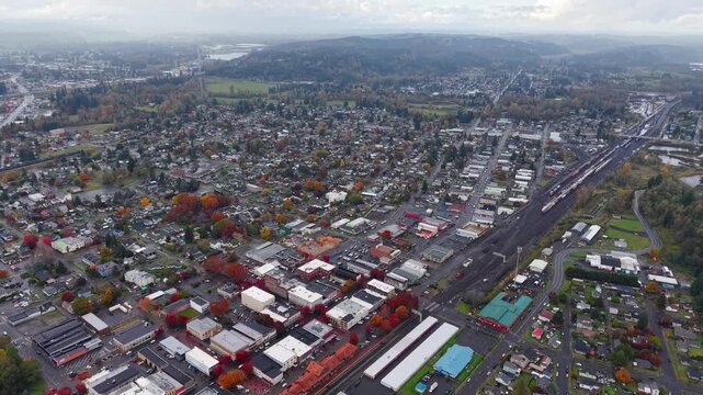 Aerial drone shot over Centralia city streets and houses at sunset during autumn with fall foliage