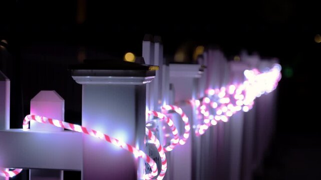 Colorful string lights at night. Close up of glowing outdoor decorative lights.