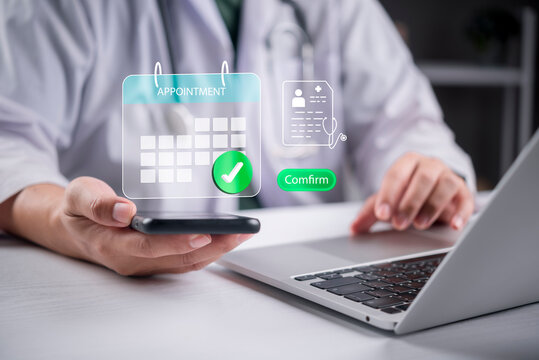 Doctor hands using smartphone laptop confirming telemedicine medical appointment. Holographic calendar checkmark digital health record UI concept.