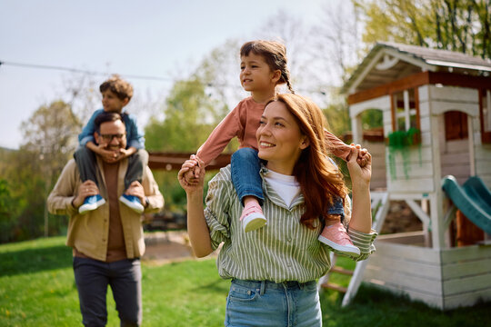 Carefree parents enjoying with their kids at playground in spring.