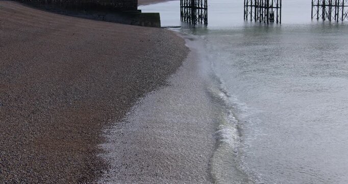 Shot off waves breaking on a Pebble gravel beach at Brighton