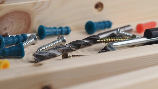 Tool close-up showing screws and drill bits on wood