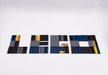 Naklejka premium Bologna - Italy - April 14, 2026: The word Lego spelled out with colorful plastic building blocks on a clean white background.