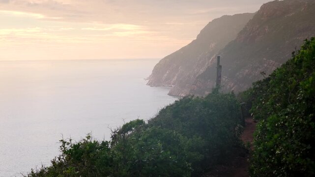 Vibrant sunrise view of rugged coastal features of Robberg Marine Protected Area