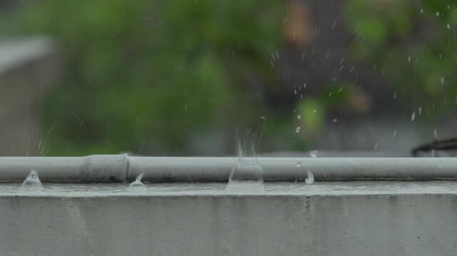 Close view of pipe under heavy rainfall conditions