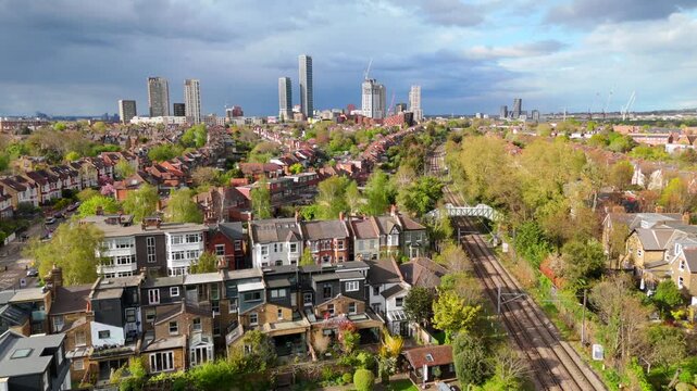 Drone shot London skyline with traditional housing estate and new build skyscrapers