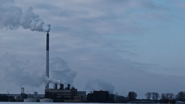 Steam releasing from large chimneys at a factory