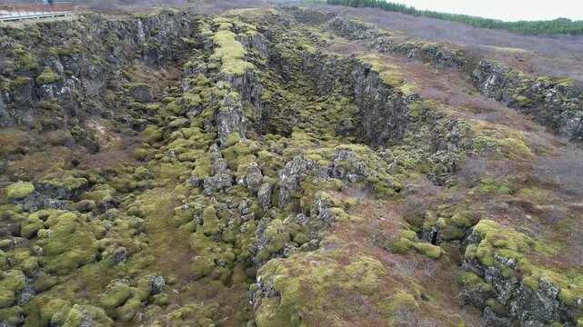 Drone view flying over the dramatic Silfra fissure landscape in Iceland. Tectonic plates of Eurasia and North America separating