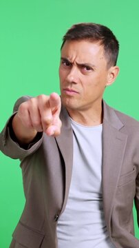 Angry businessman pointing his finger at camera