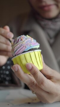Savoring a colorful cupcake in a casual moment