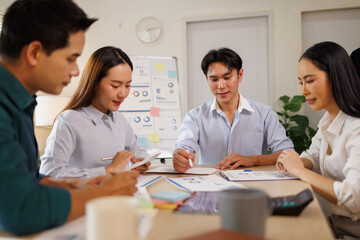 Fototapeta premium Asian business team collaborating on business strategy in office
