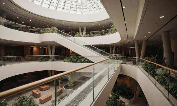 Atrium Garden Architecture Modern multilevel interior with lush greenery glass walkways and large skylight in a bright workspace