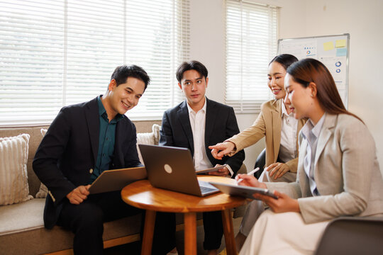 Asian business team collaborating in a modern office meeting