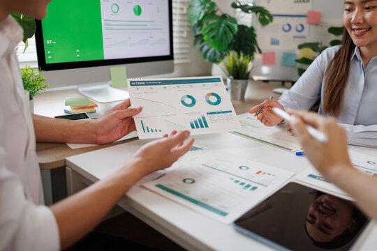 Analyzing business data during an office team meeting