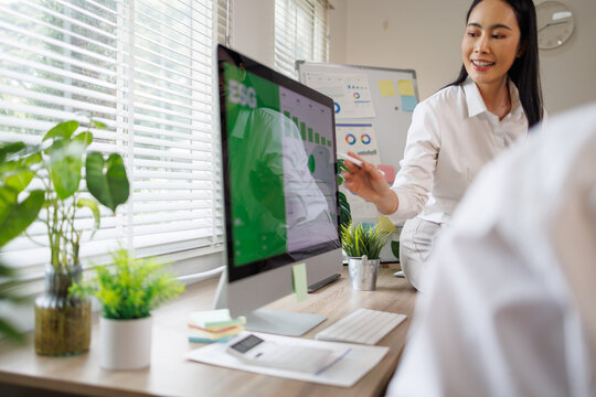Asian businesswoman analyzing esg data on computer in office