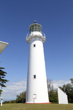 White Lighthouse on Tiritiri Matangi Island under Blue Sky