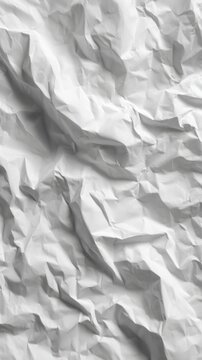 A textured surface of crumpled white paper, showcasing various folds and shadows, creating a visually dynamic and abstract appearance.
