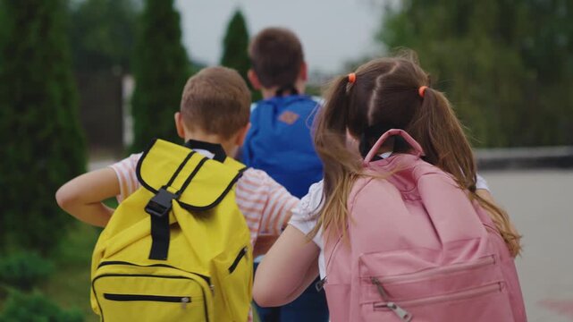Kids going to school with backpacks, Children walking together in the morning, School day starts, Friendly classmates head to school, Back to school moments, Happy kids outdoors, Walking to school as